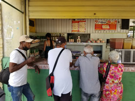 cuban people standing in line at a food stall in Havana
