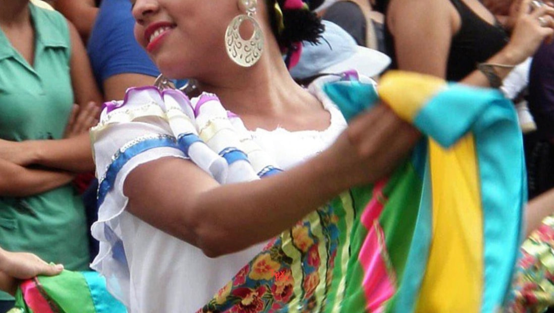 nicaraguan dancer in a colorful skirt performing in a parade